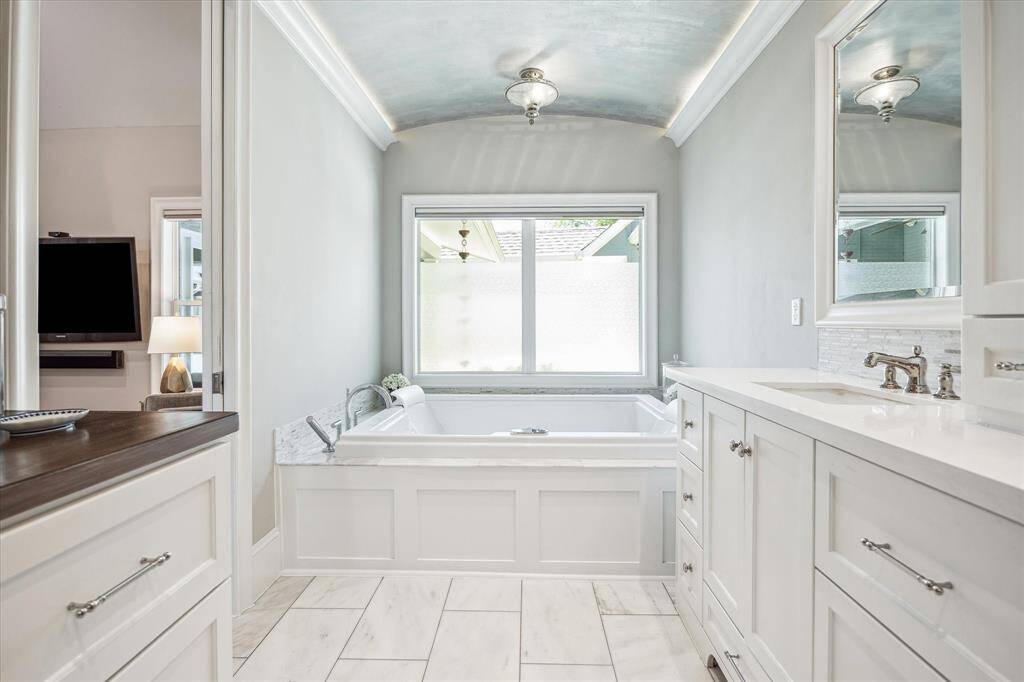 Spacious jetted spa tub with room for two — a relaxing feature in the large primary bathroom.