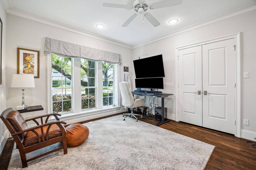 This versatile first-floor bedroom is currently set up as a home office and features a convenient Queen-sized Murphy bed with built-in shelving. A full bathroom is just steps away in the hallway.