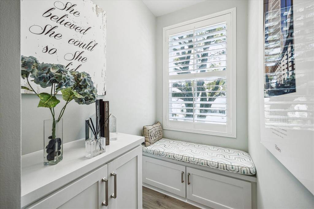 Cozy reading nook adjacent to a built-in desk, perfect for relaxation and productivity.