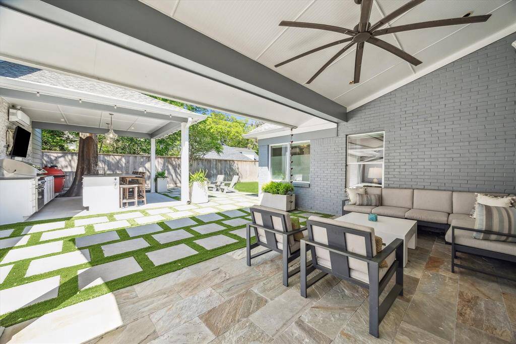 Discover the ultimate entertainer's backyard with two covered patios: one for relaxation and one for cooking and hosting.