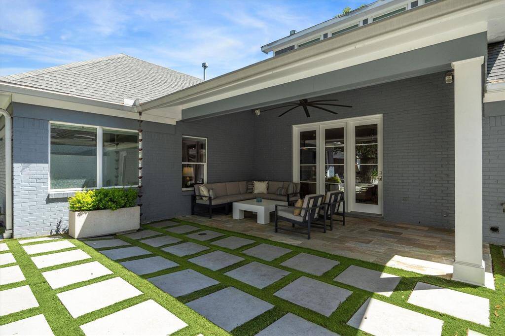 Enjoy the spacious covered patio, complete with a large ceiling fan, built-in speakers, and stunning backyard views.