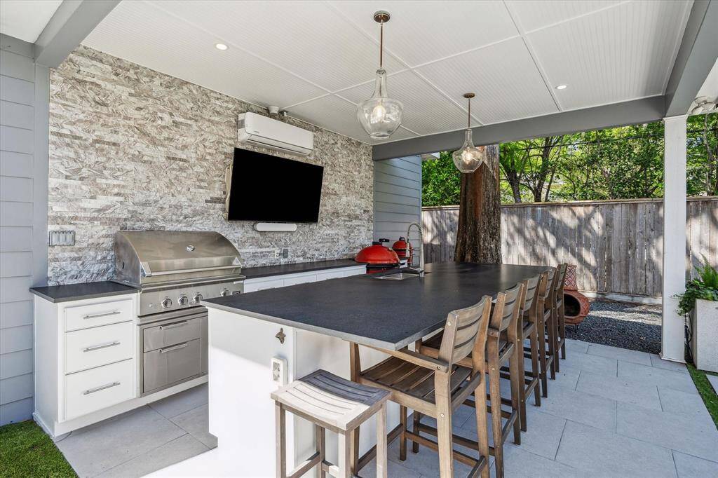 Discover the ultimate summer kitchen, built in 2022, featuring a built-in gas grill, space for an XL Egg, and ample storage. Enjoy the expansive island with a prep sink and seating for five or more. Stay comfortable year-round with the A/C mini split system for heating and cooling.