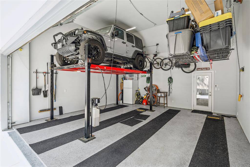 In 2022, the garage was fully renovated, with the roof pitch raised to accommodate a car lift, making it capable of holding three cars. A cargo lift was also added for additional storage solutions, and the garage features durable epoxy flooring.