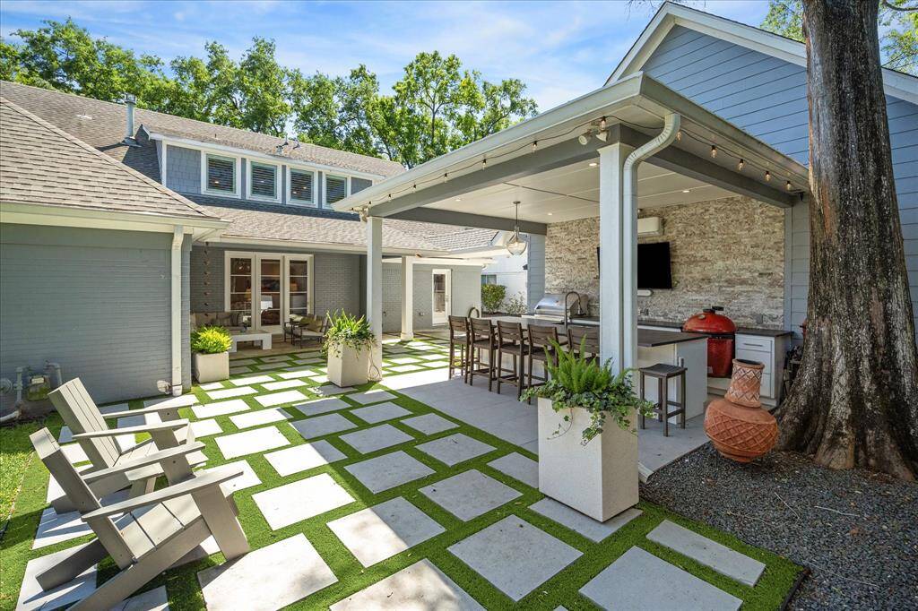 In 2022, the summer kitchen, garage, and covered breezeway were added, completing the backyard and transforming it into an entertainer’s paradise.