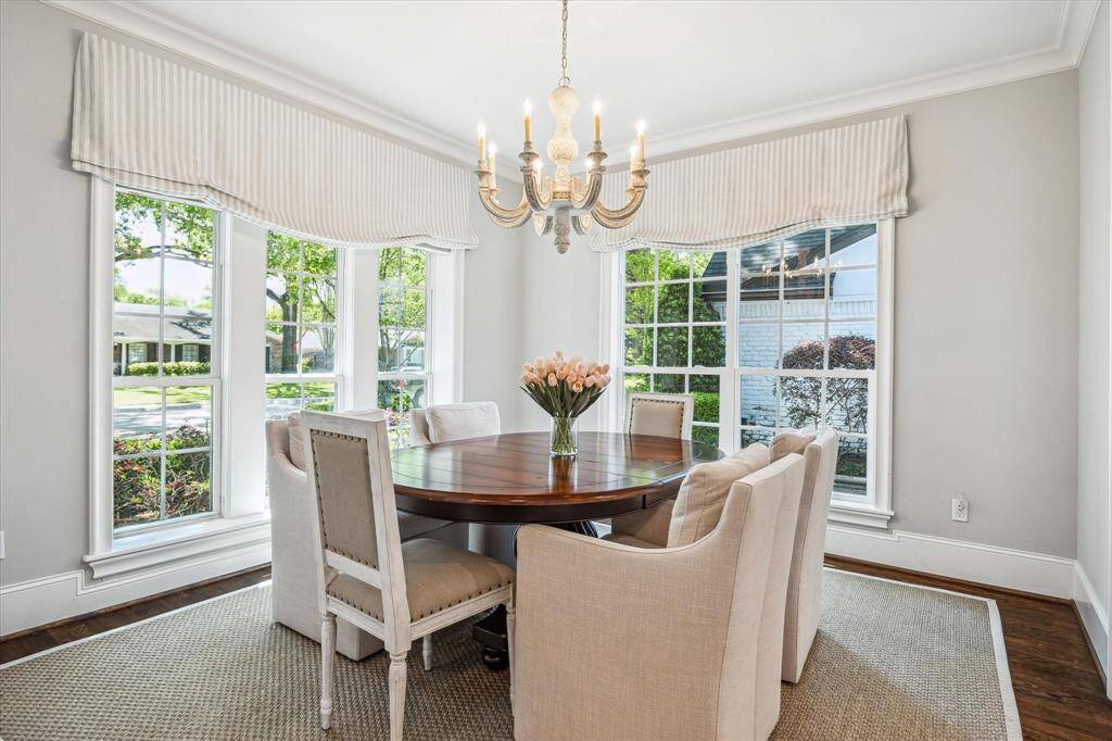 This light-filled breakfast room features elegant crown molding and plenty of charm. While perfect for casual dining, it could also serve as a cozy Mahjong room or inviting reading nook.