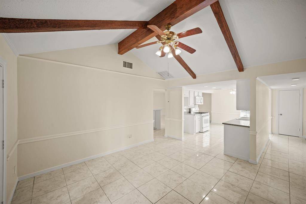 The combination of beautiful ceiling lines and easy care tile flooring sets a stunning backdrop for the den space, adding warmth, texture, and architectural interest.