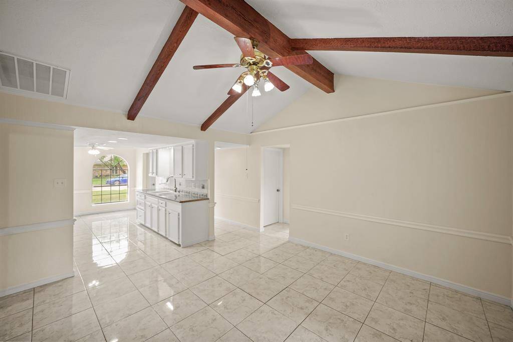 The exposed beams and high ceiling, creates a dramatic focal point that complements the overall aesthetic.