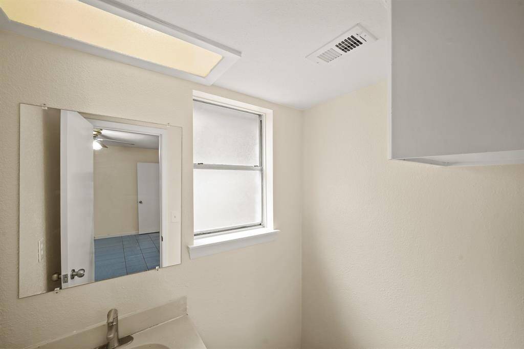 The primary bathroom is private and inviting, roomy enough to move around comfortably.