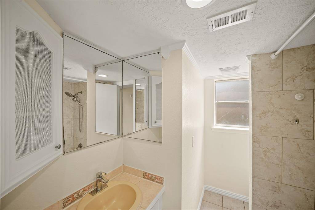 The  secondary bath provides plenty of space, seamlessly blending comfort and functionality for a refreshing and relaxing retreat.