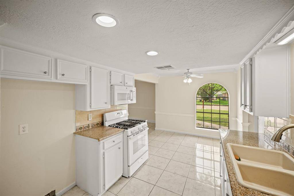 Granite countertops paired with a coordinating backsplash not only provide a durable and elegant surface for food preparation.