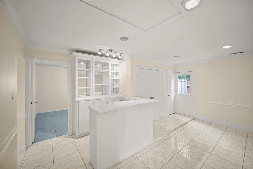 The stylish wet bar in the living room is perfect for entertaining guests, mixing up your favorite drinks, or enjoying a casual night in.
