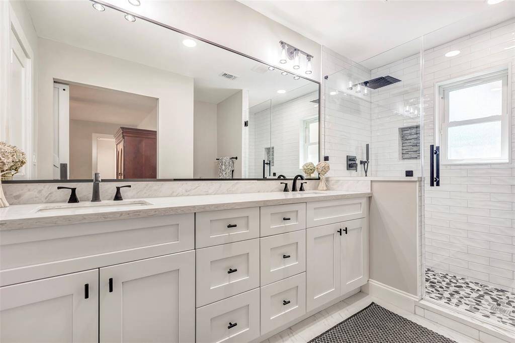 Wonderful double-sink marble quartz topped vanity with ample storage.