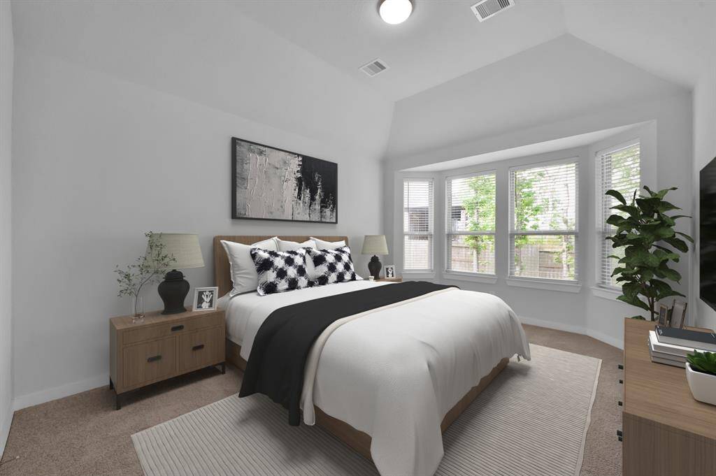 Retreat to a serene first floor primary suite with bay windows and a luxurious en suite bath. Virtually staged.