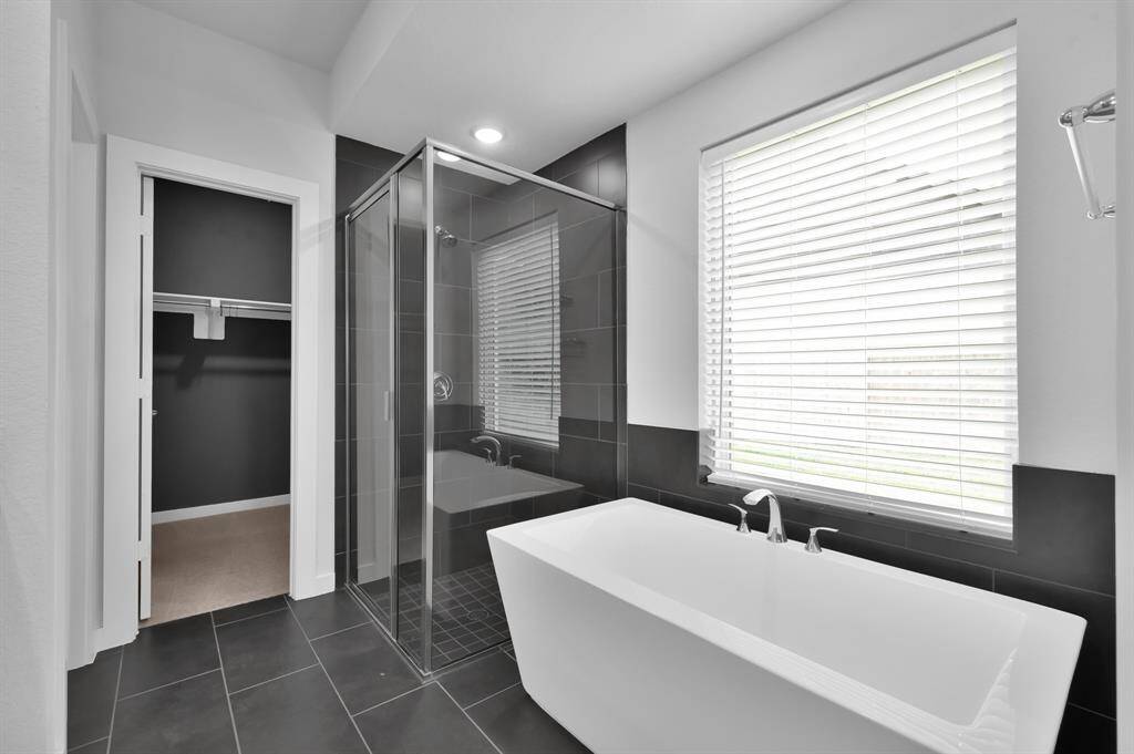 The stand alone soaker tub is calling you to relax after a long day.