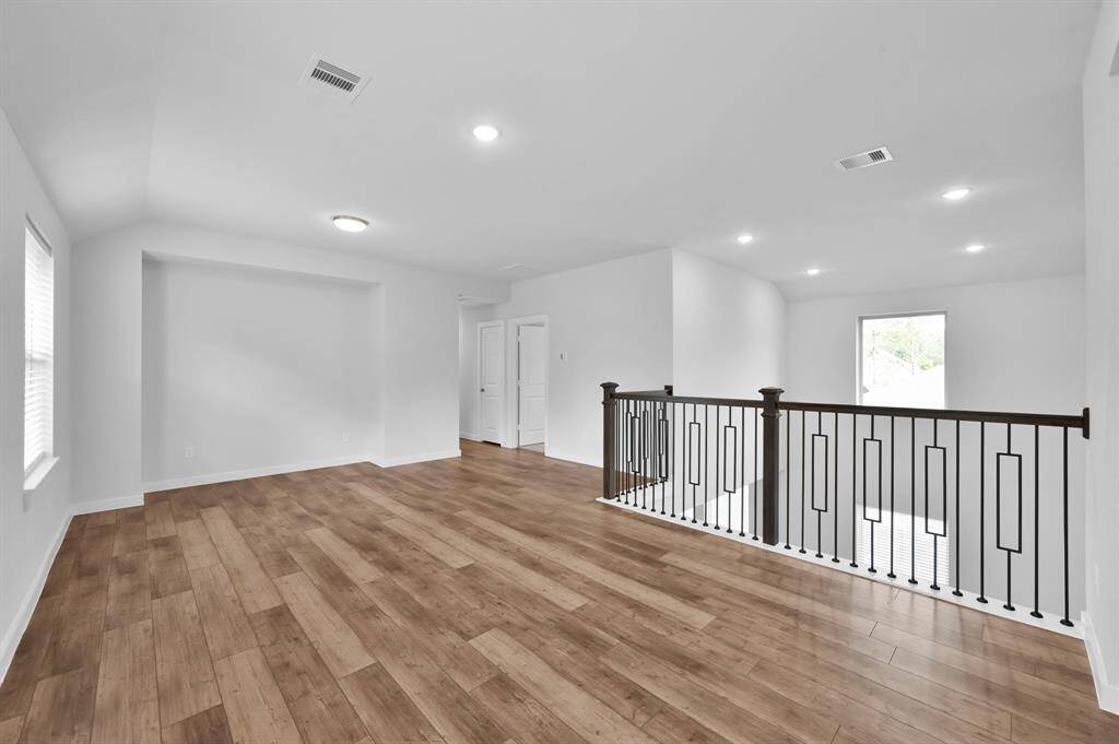 This versatile flex space is perfect for a craft room, playroom, workout, or media room.