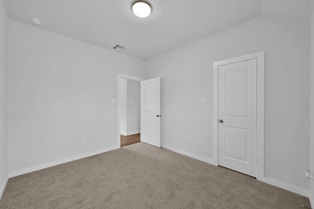 All upstairs bedrooms are generously sized, offering comfort and flexibility. This upstairs bedroom has a large walk-in closet and the home's fourth full bath with a shower. Your family or guest will love this added privacy.