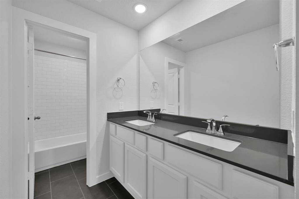 Upstairs bathroom with dual sinks.