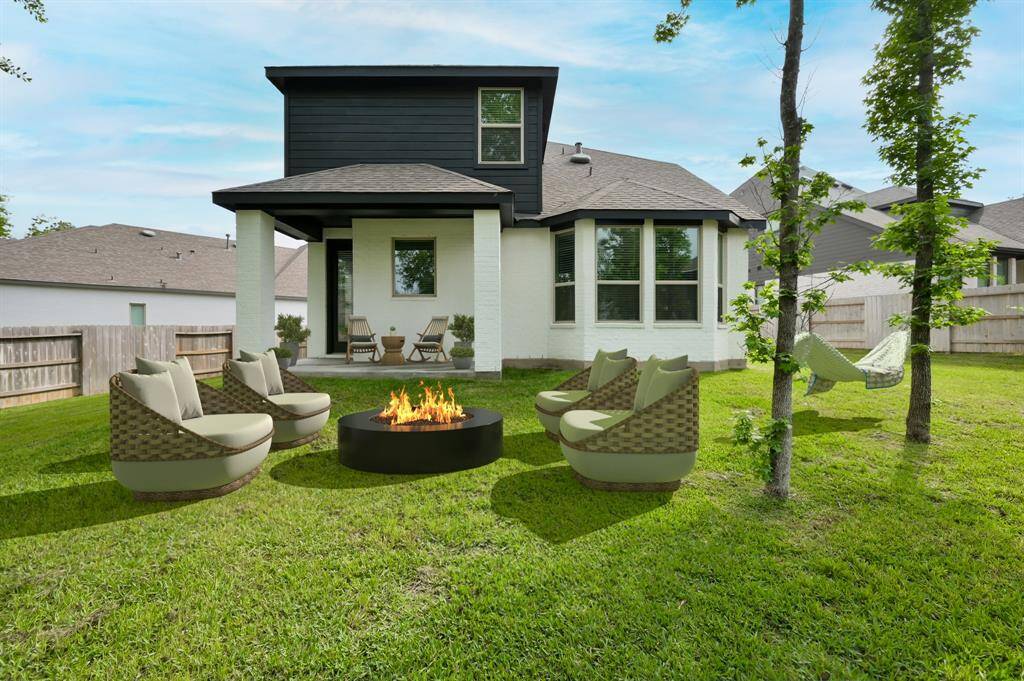Covered back patio overlooks a spacious yard—perfect for entertaining, outdoor dining, or a future pool. Virtually staged.