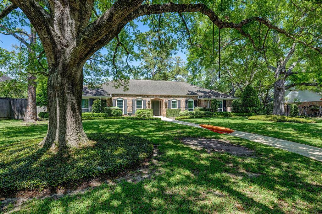 10918 Timberglen features lush landscaping and a long walkway.