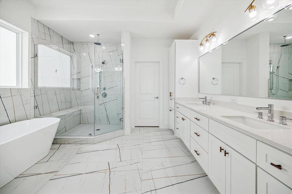 Primary bathroom double sink and a gorgeous freestanding soaking tub.