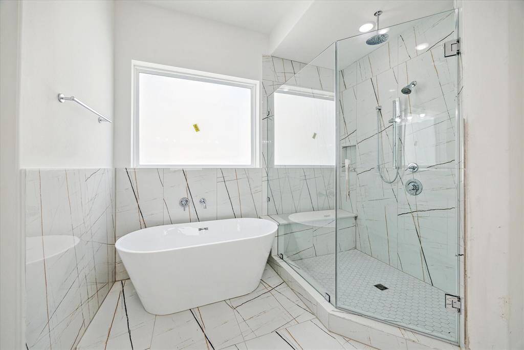 Beautiful quartz, and designer tile in Another one of your bathrooms with shower/tub.