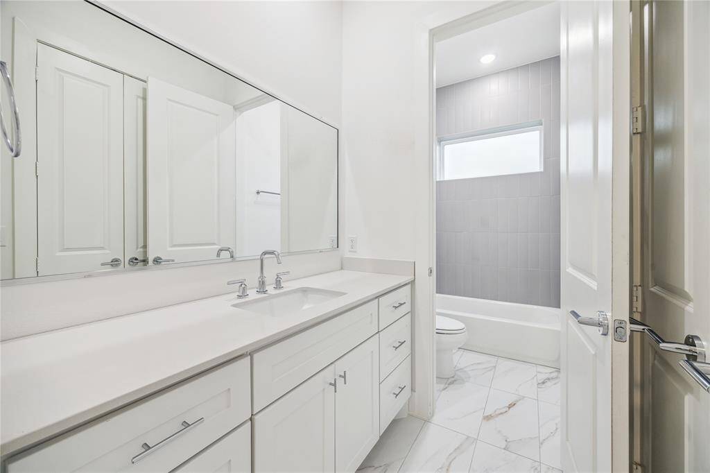first floor secondary bathrooms with sweeping floor to ceiling tile