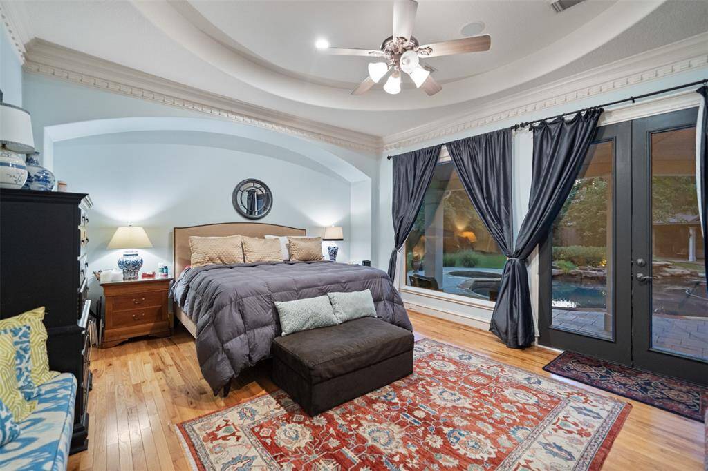 ONE OF TWO PRIMARY BEDROOMS ON FIRST FLOOR WITH VIEW AND ENTRY TO THE POOL