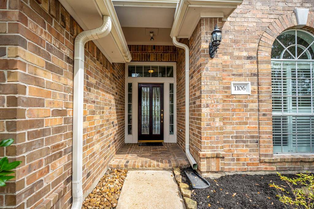 The covered brick front porch area is an easy to maintain brick elevation - with beautiful coach lighting.