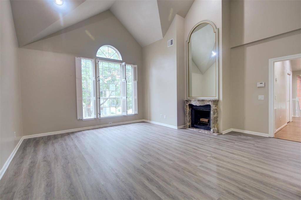 Primary bedroom with fireplace and tall ceilings