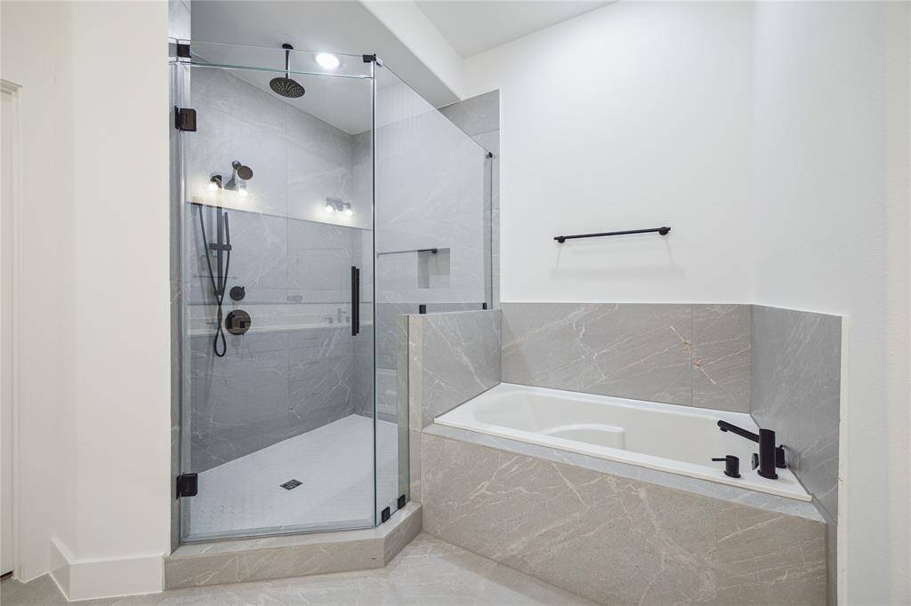 The shower has three shower heads including a rain shower head
