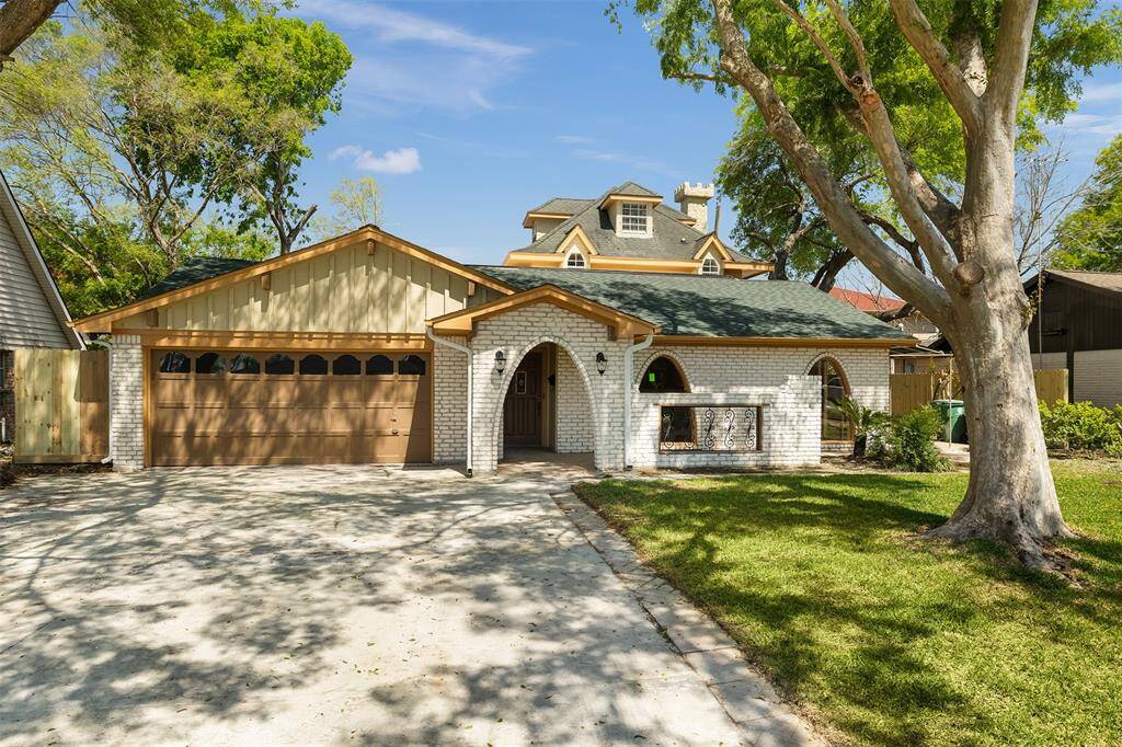 Welcome to 11219 Sagewood Drive. Your shaded driveway awaits! This inviting front view showcases ample parking with a three-vehicle-wide driveway and an attached two-car garage, all framed by mature trees and charming curb appeal.