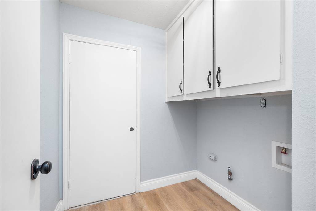 The utility room, conveniently located inside the property off the garage, offers ample storage cabinets and connections for both gas and electric dryers, as well as a washer connection. It provides a functional and organized space for laundry needs.