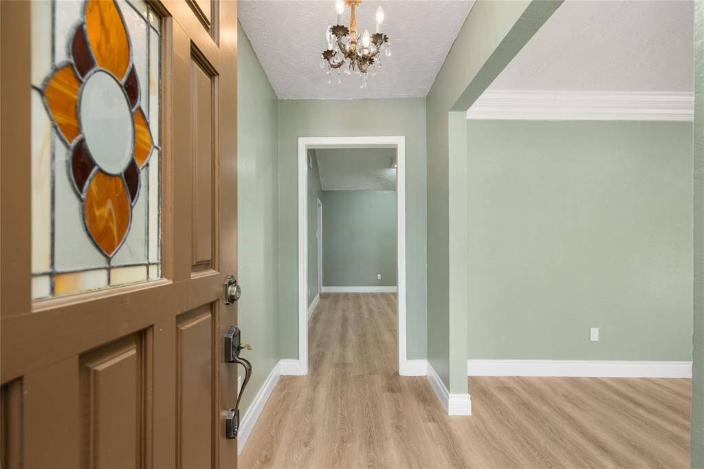 Welcome inside! The freshly painted light green interior offers a warm and inviting ambiance. Ceilings, trims, baseboards, and crown molding have all been updated, complemented by new vinyl wood flooring that flows throughout the first and second stories.