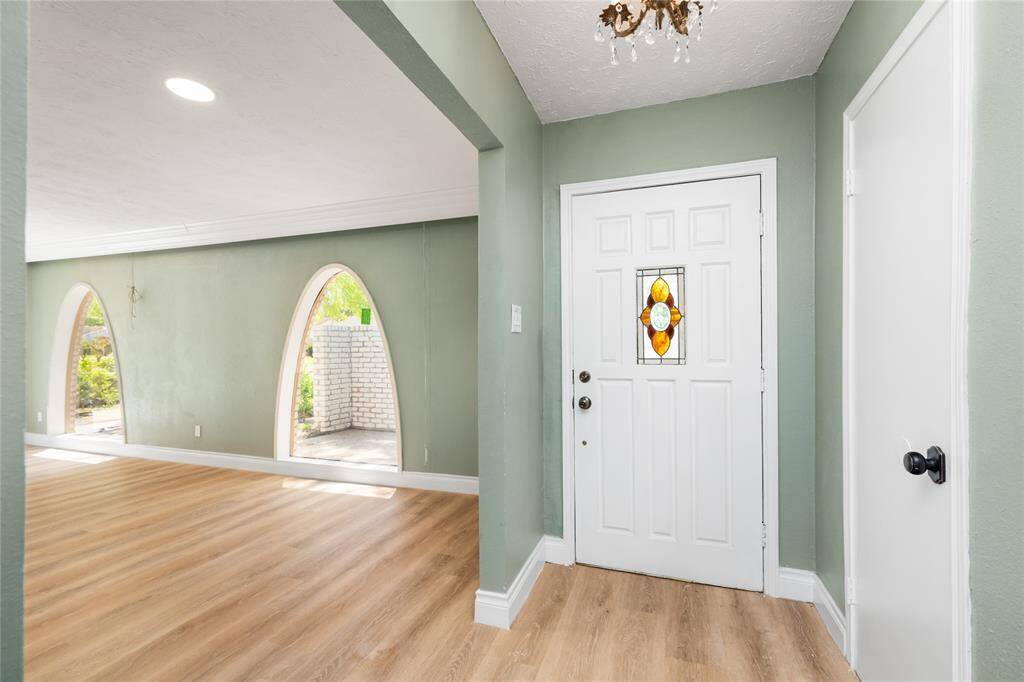 Lighting has been thoughtfully updated throughout the home with added recessed can lights for a modern touch, while select original chandeliers have been preserved to maintain the property’s classic charm.