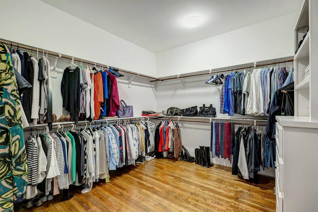 Huge walk-in closet with plenty of room to hang it all—plus built-ins to keep things neat and organized.