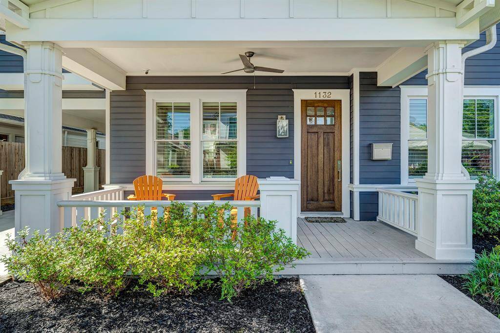 Spacious and welcoming front porch with a ceiling fan, offering a nice view of the front yard and street.