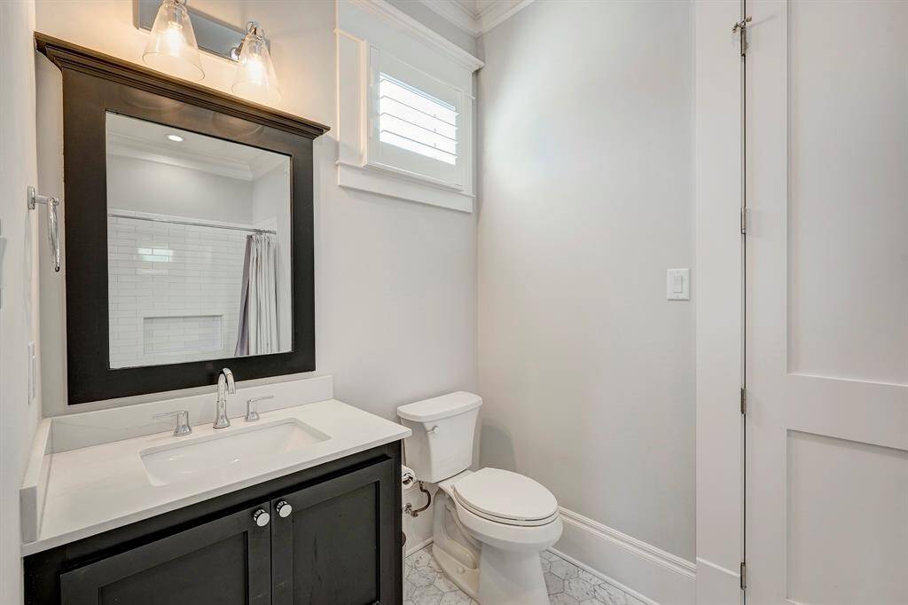 This secondary bathroom offers a perfect mix of modern style and timeless vintage elements.