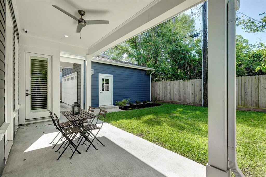 The back porch offers plenty of room for seating and dining, with a ceiling fan to keep you cool on warm days.