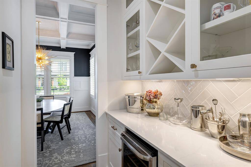 The butler's pantry is equipped with a wine fridge, bottle storage, and additional cabinet and countertop space.