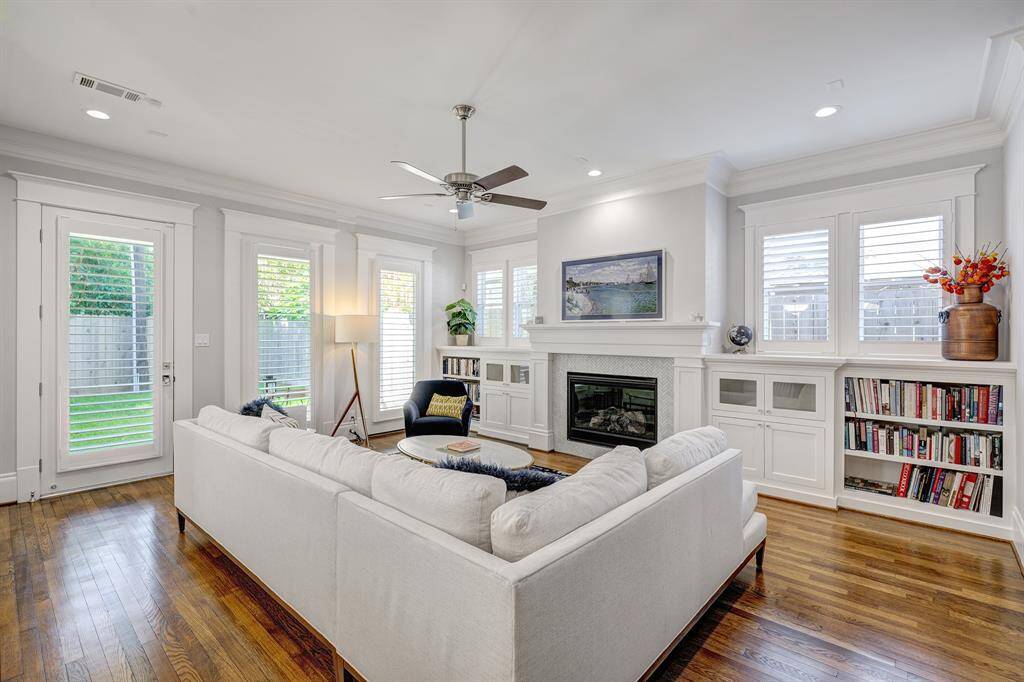 Spacious family room with an abundance of windows,built-ins, and a fireplace. Door leads to the back porch and backyard.