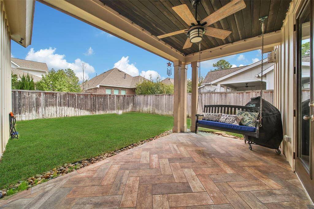 Side patio that has cool decking and pergola for additional patio area.