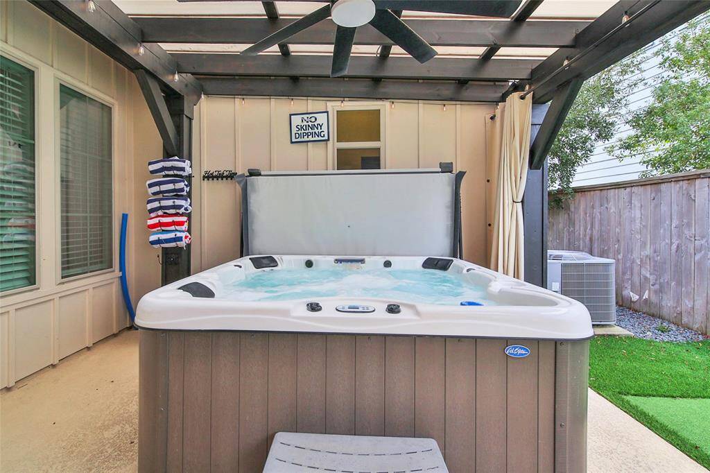 Hot tub tucked away on side of patio.