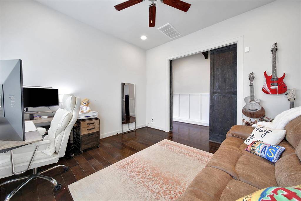 Just off the entry is the office with a custom decorative wall.