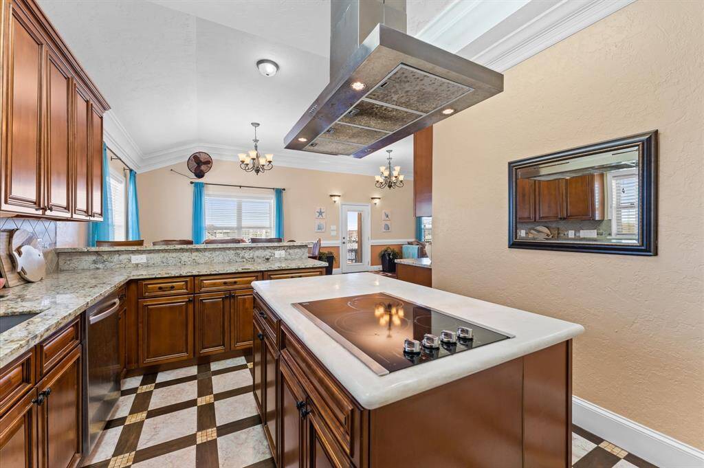 Gourmet meets the coast! This beautiful kitchen has lots of cabinet storage space, gleaming granite countertops! Look at that range hood ready to assist your with your memorable meals!