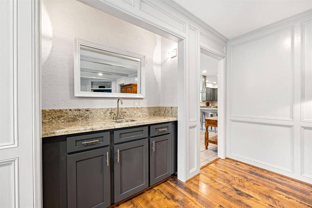 The wet bar is conveniently located next to the kitchen entrance.