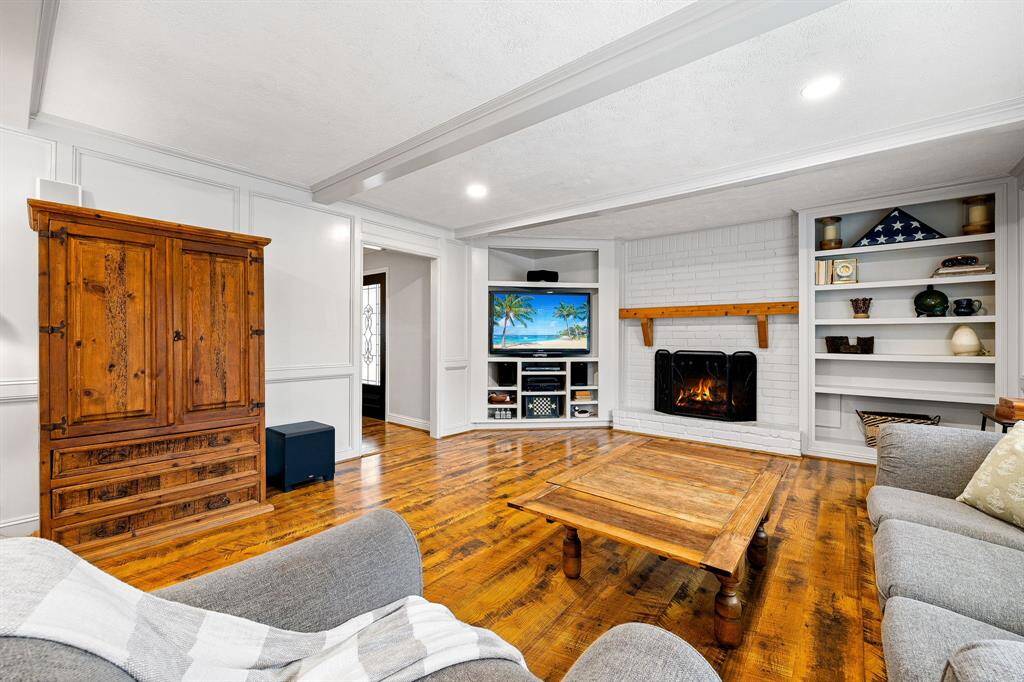Built-in shelving and brick-adorned gas log fireplace make it the perfect space to enjoy cozy nights.