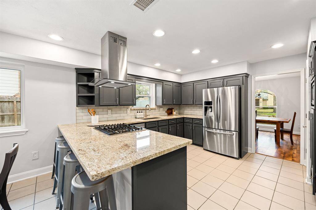 Beautifully updated kitchen features stainless steel appliances, gas cooktop and vent hood with an abundance of counterspace.