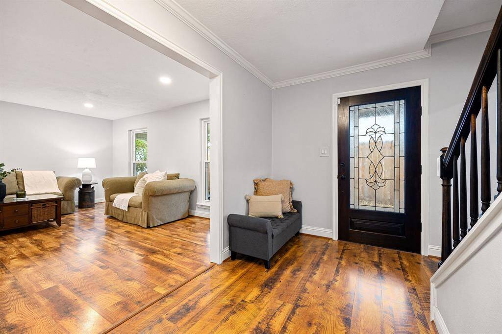 Upon entering, you're welcomed by gorgeous wooden floors repeated throughout the main living areas of the house.