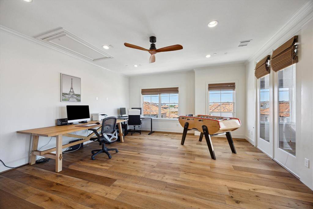 The first-floor full bath features warm wood cabinetry and a limestone countertop.