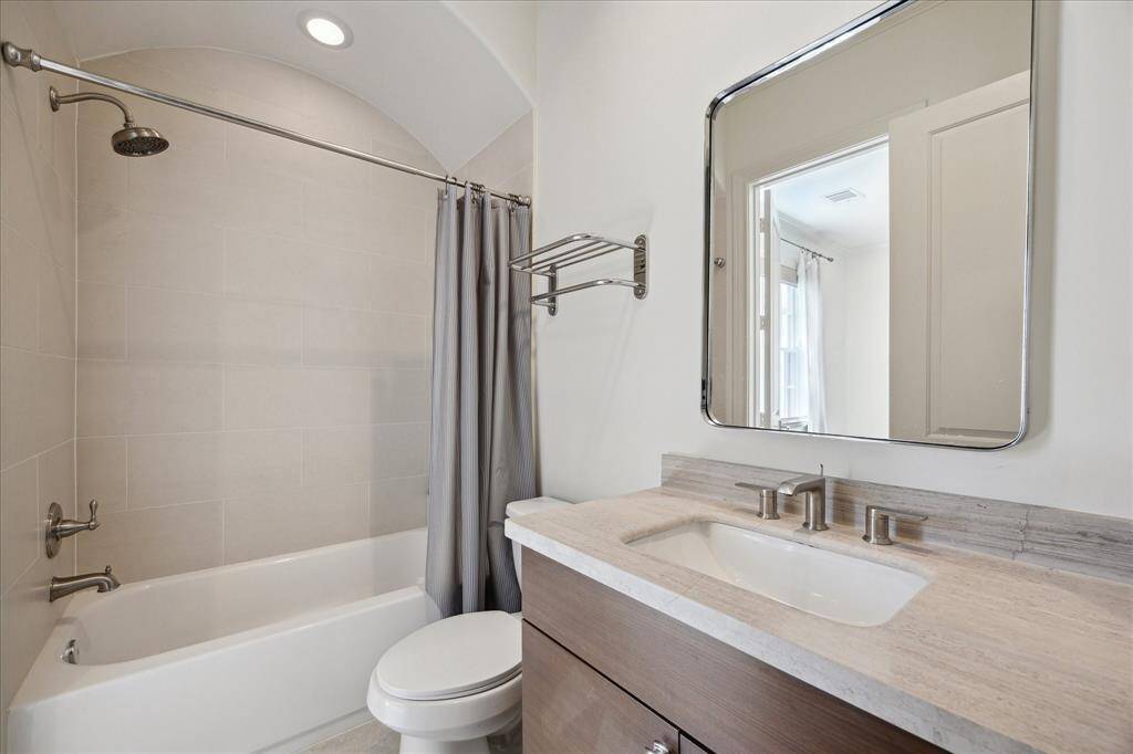 Sunlight and sweeping views fill this space. Double doors open to a large rooftop deck, with access to a mechanical room perfect for additional storage.